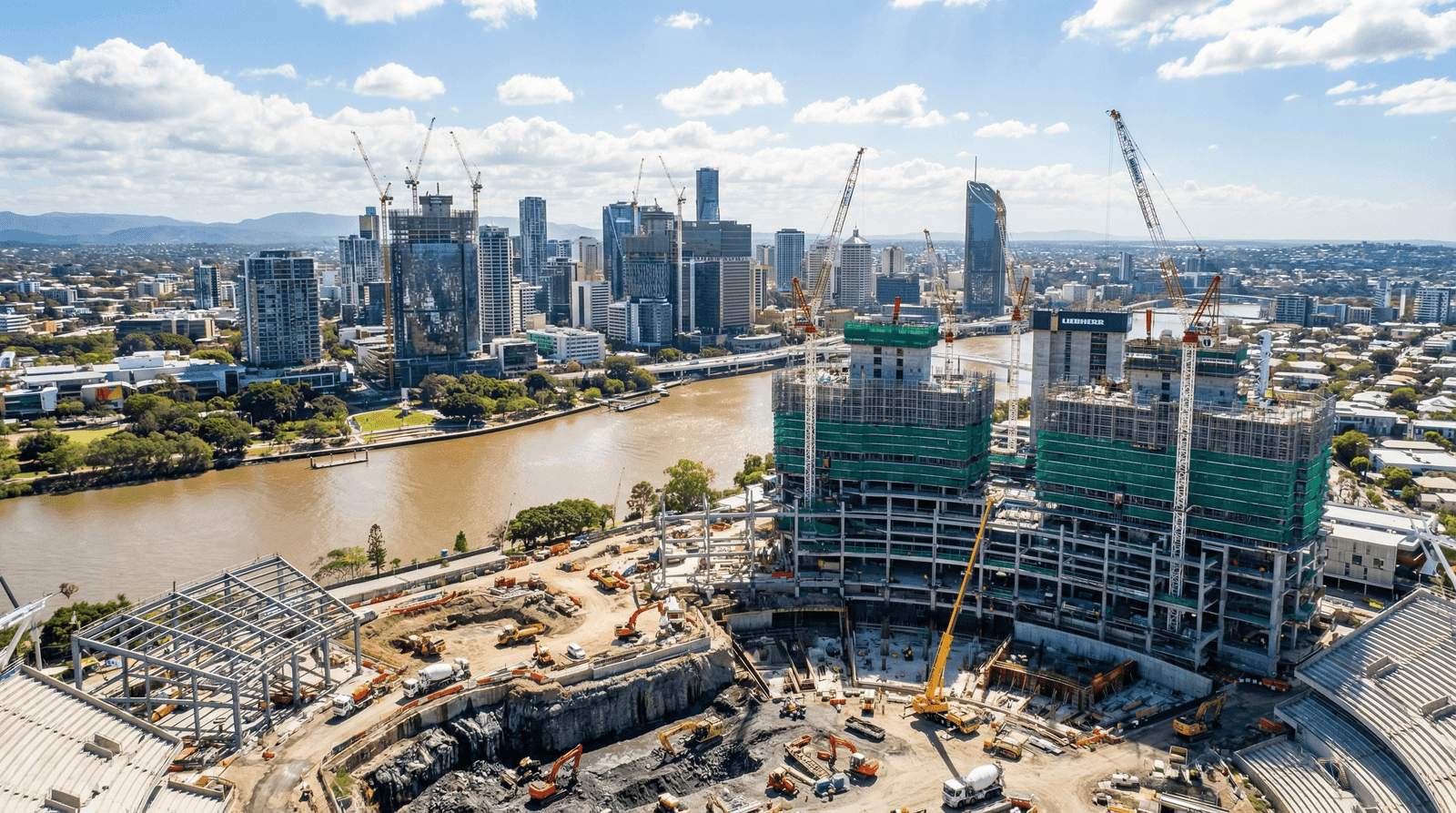 Aerial view of major construction and infrastructure development in Brisbane, cranes and construction sites across the city skyline with Brisbane River visible